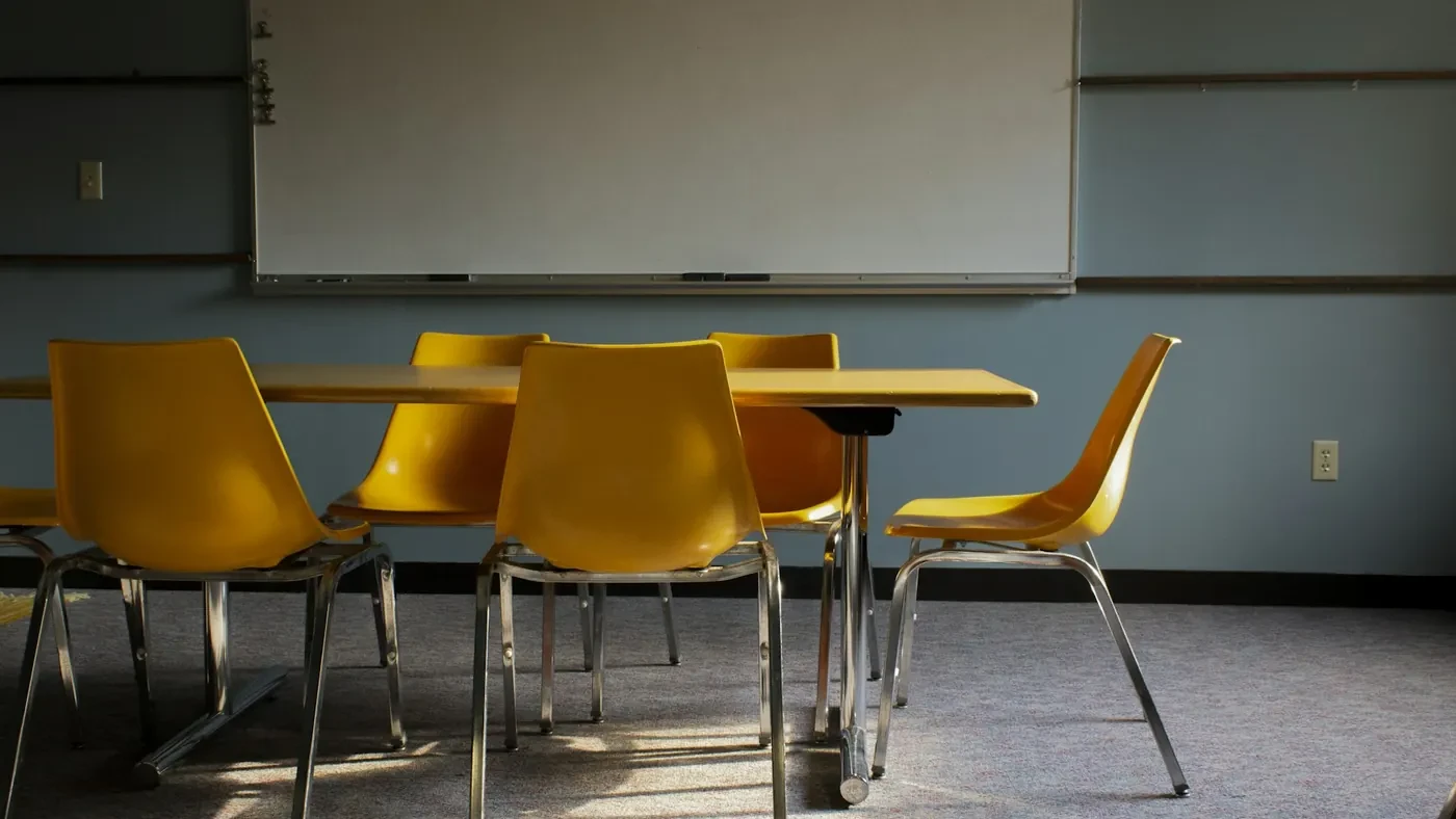 Empty classroom with yellow chairs