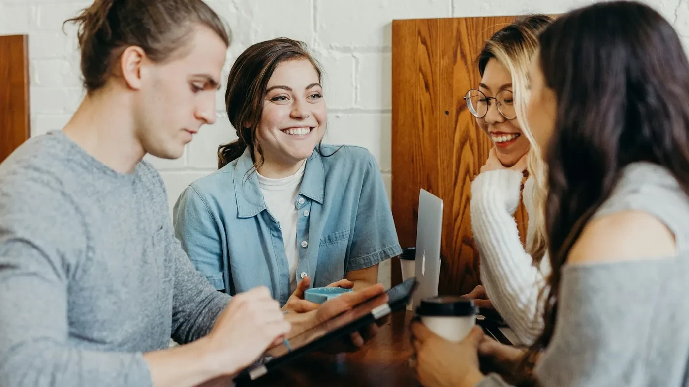 Adults collaborating around a tablet