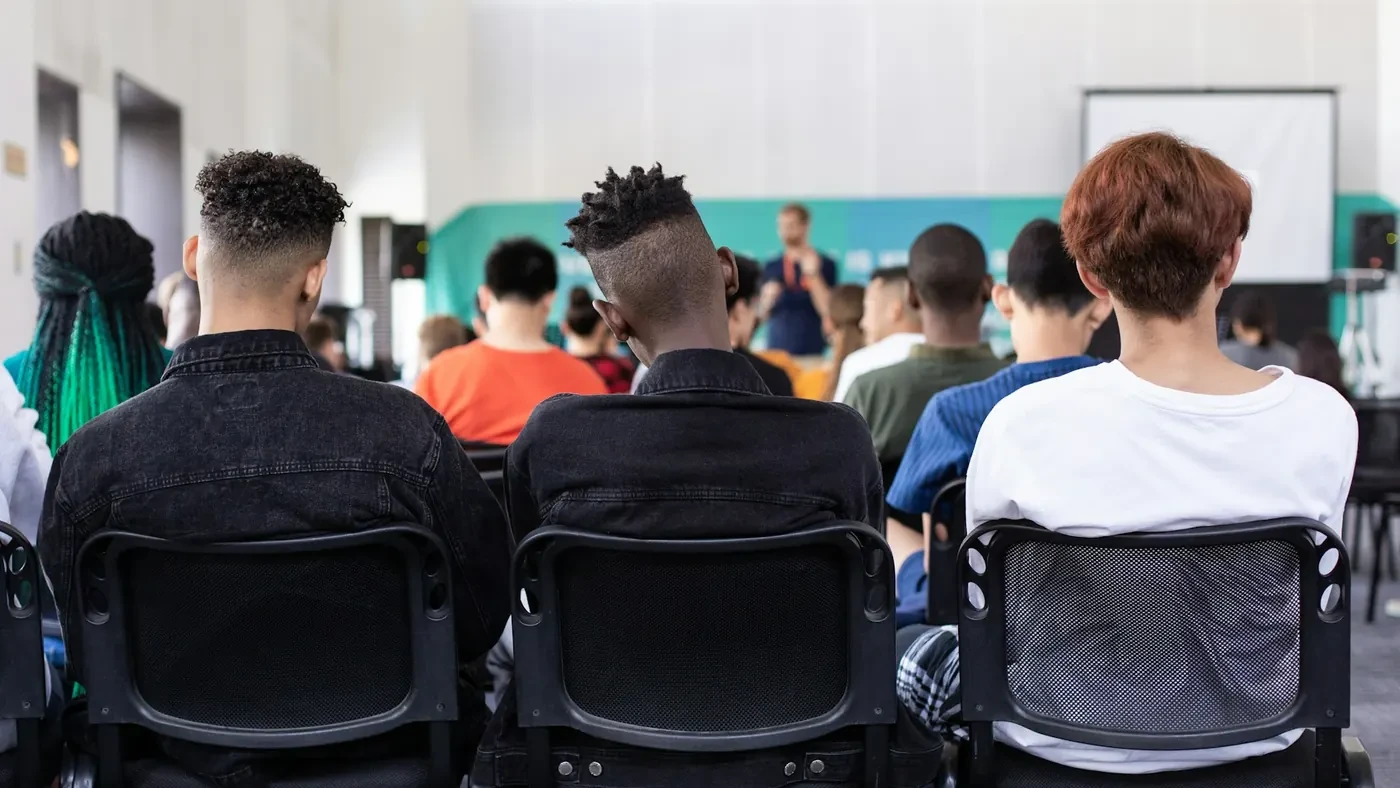 Students seated facing the front of a classroom