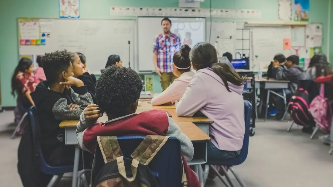 Teacher standing in front of a seated classroom