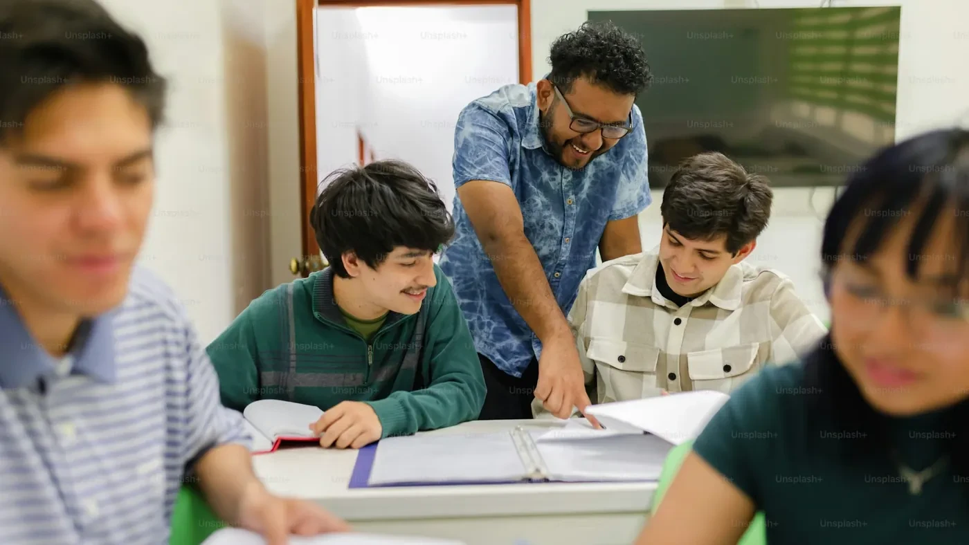 Teacher helping students work together at a table